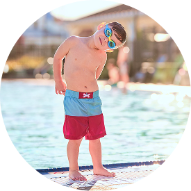 young boy shaking water out of his ear