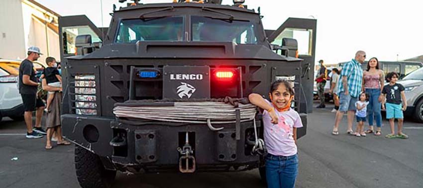 Girl standing in front of a LENCO car